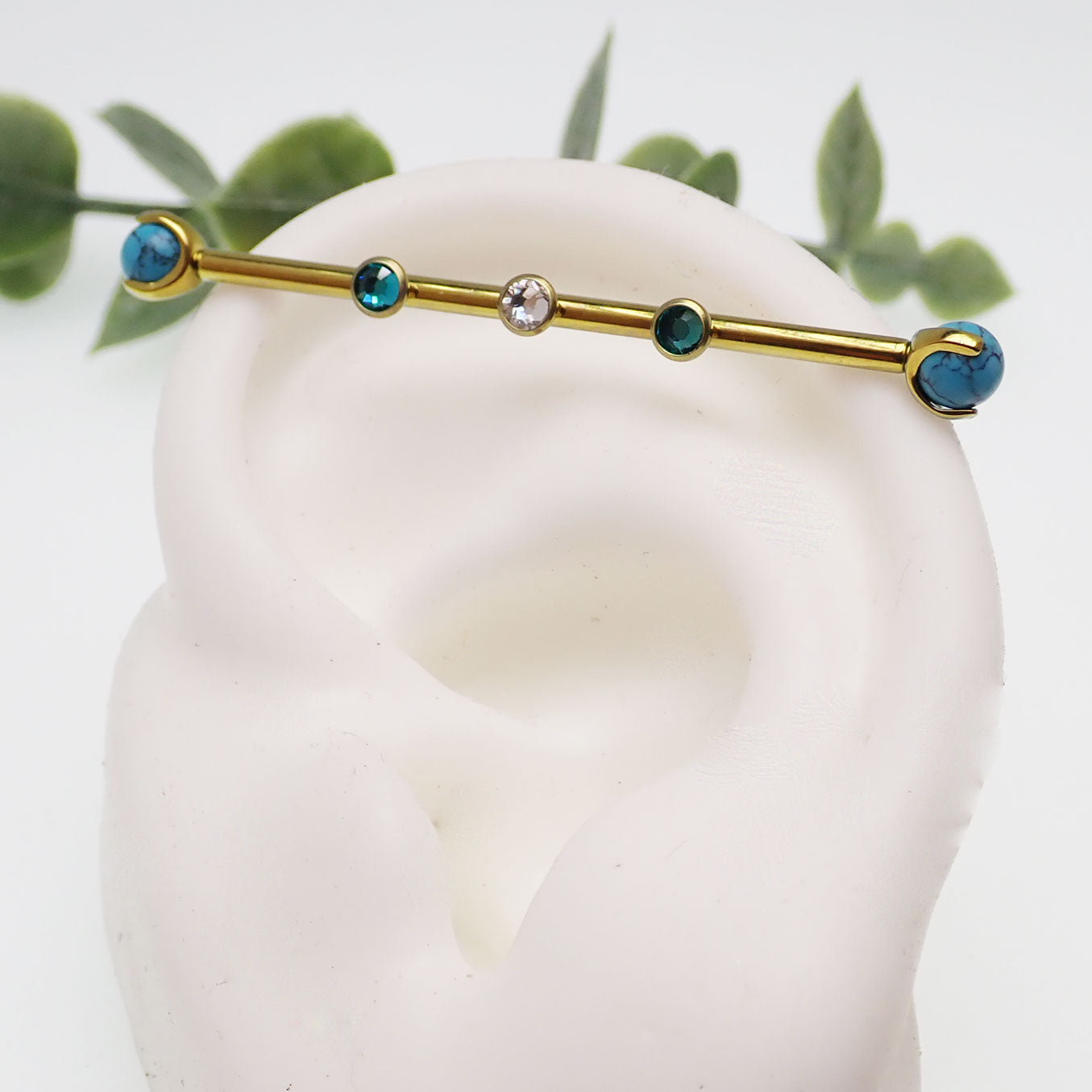 Turquoise and zircon titanium industrial piercing in 14g with a 32mm length, featuring a sleek industrial bar from Body Clickers.