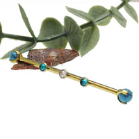 Turquoise and zircon titanium industrial piercing in 14g with a 32mm bar from Body Clickers, featuring a sleek industrial design.