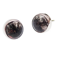 Close-up of a Moss Agate and Tourmalated Quartz titanium push fit top for body jewelry, showcasing the intricate stone pattern.