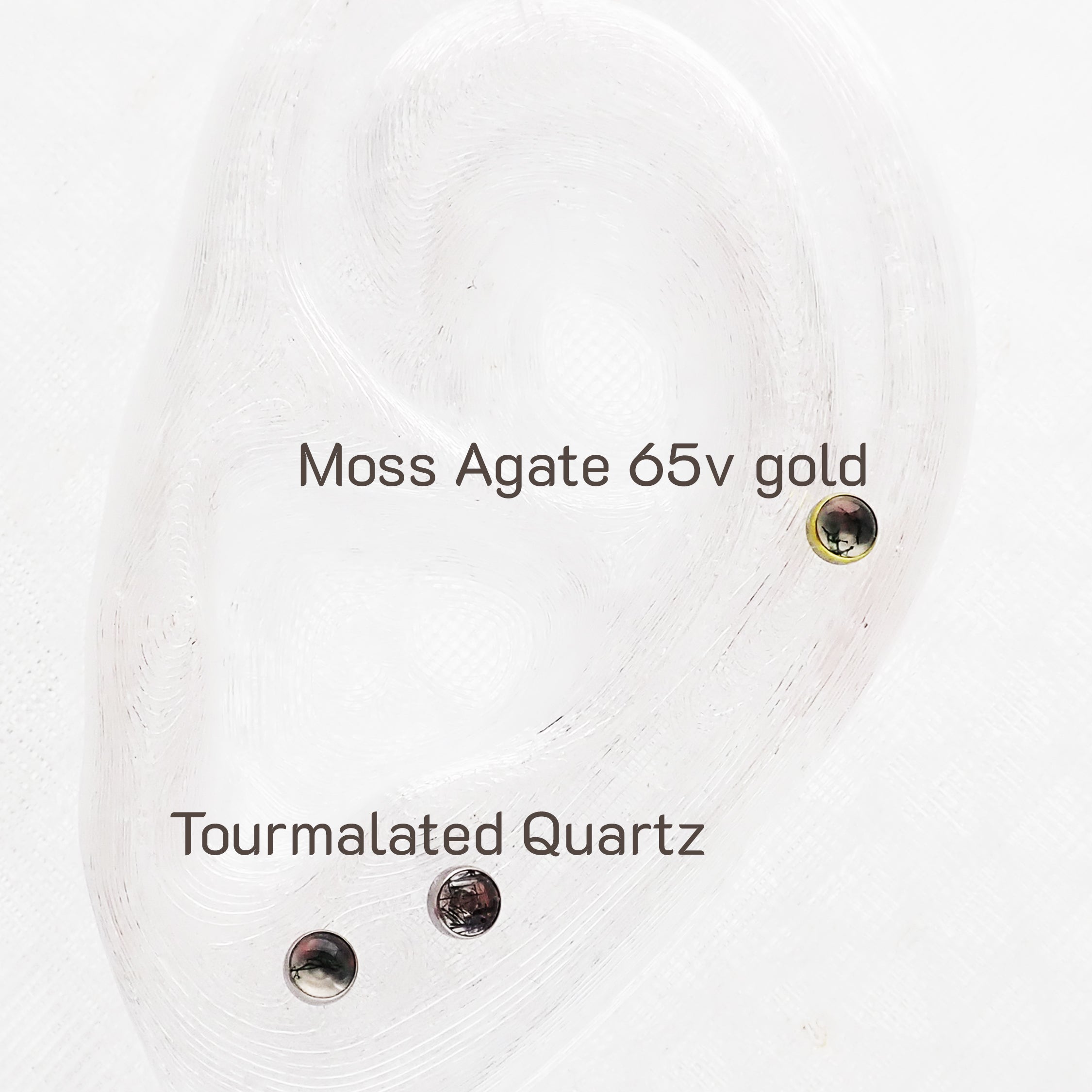 Close-up of a moss agate and tourmalated quartz titanium push fit top for body jewelry by Body Clickers.