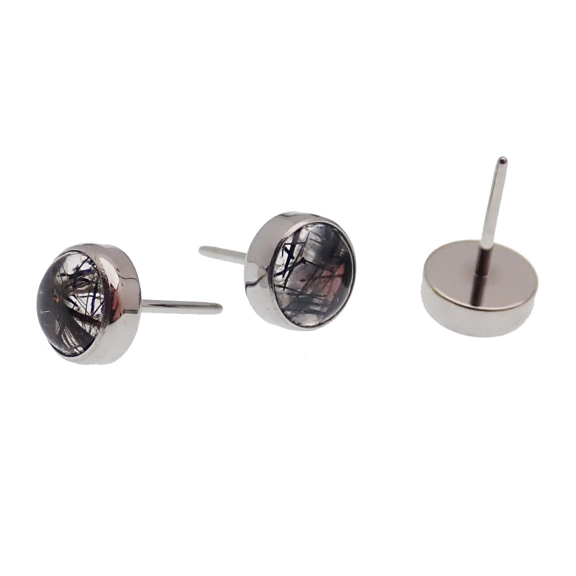 Titanium push fit top with moss agate and tourmalated quartz for body piercing, featuring natural stone designs.