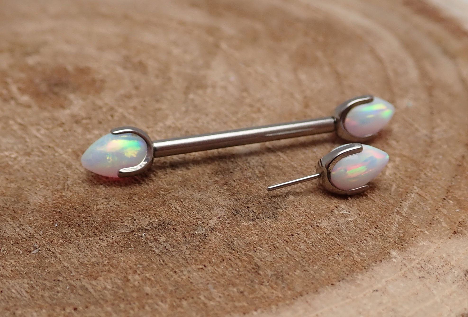 Titanium push fit nipple piercing by Body Clickers featuring white fire opal bullet cones, 16g, 12mm length.