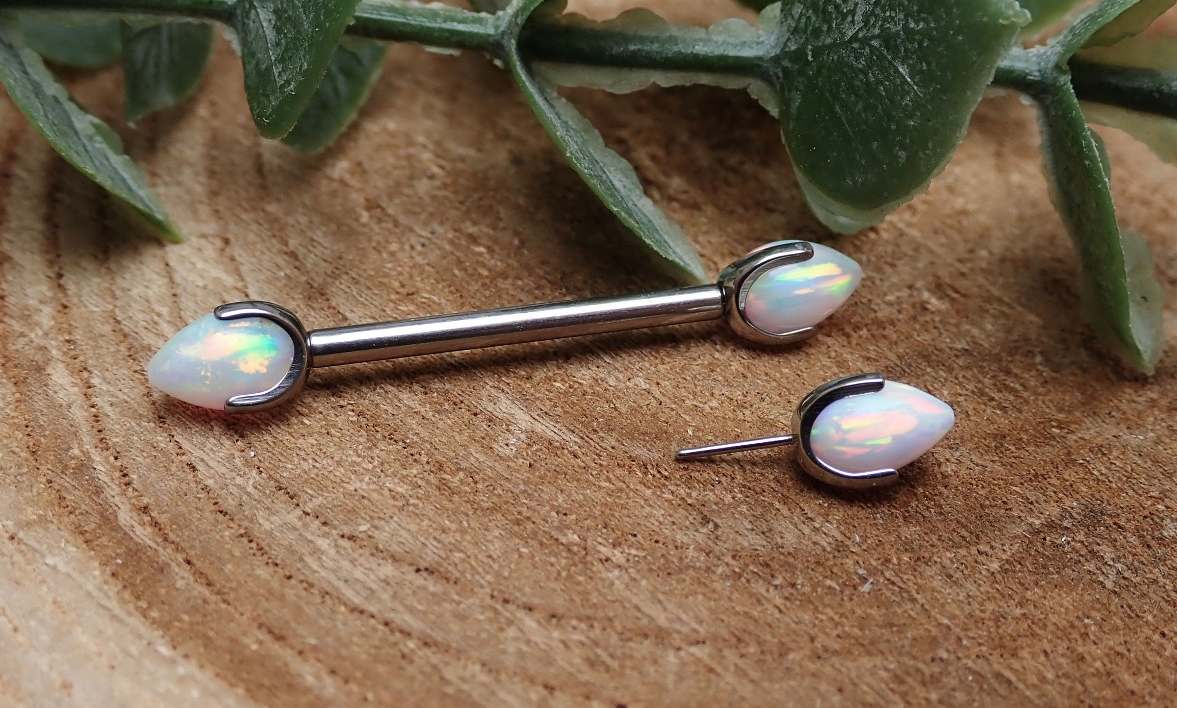 Titanium push fit nipple piercing with white fire opal bullet cones, 16g, 12mm, by Body Clickers.