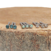 Set of 9 opal and cubic zirconia steel nose studs in 20 gauge by Body Clickers, featuring various stylish designs.