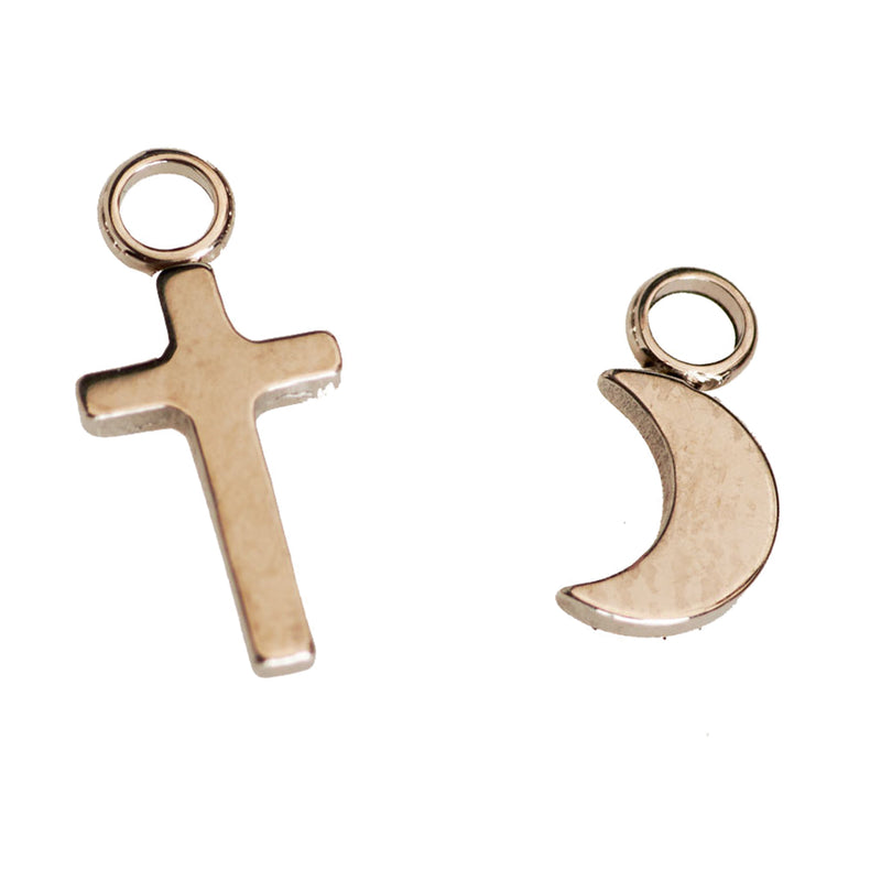 Halobes body jewelry charm featuring a cross and moon design on a silver body jewelry piece.