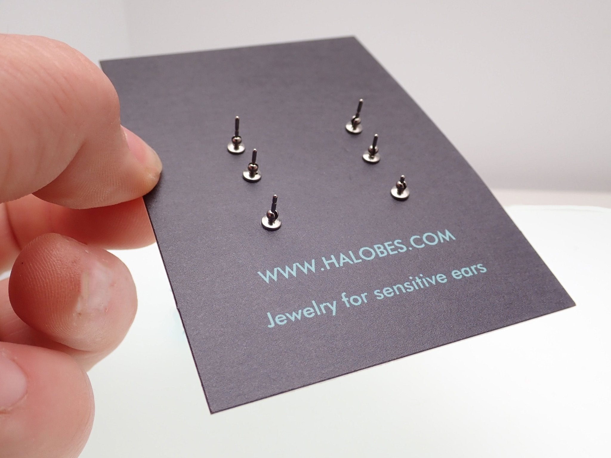 HALOBES titanium earrings with sparkling zircon crystals, featuring sleek 2.5mm hoops and a modern, elegant design.