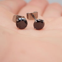 Black CZ implant titanium earrings in 20g, featuring a sleek design and secure post, by Halobes.