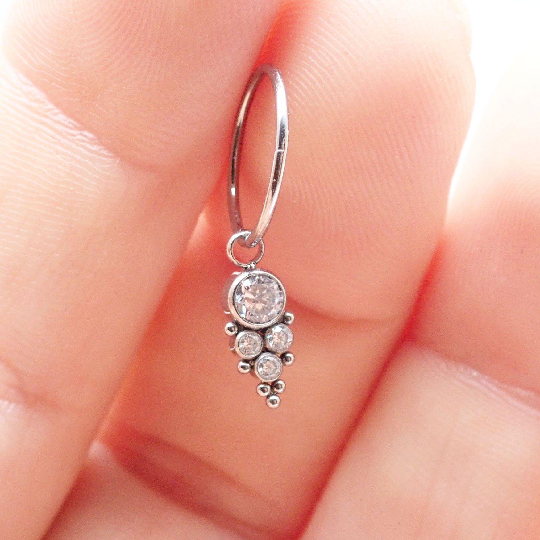 Halobes titanium charm CZ beaded cluster earrings with intricate design and sparkling cubic zirconia accents.
