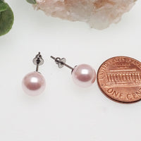 Titanium earrings by HALOBES featuring Swarovski blush pearls and sleek titanium hooks, elegant and stylish jewelry accessory.