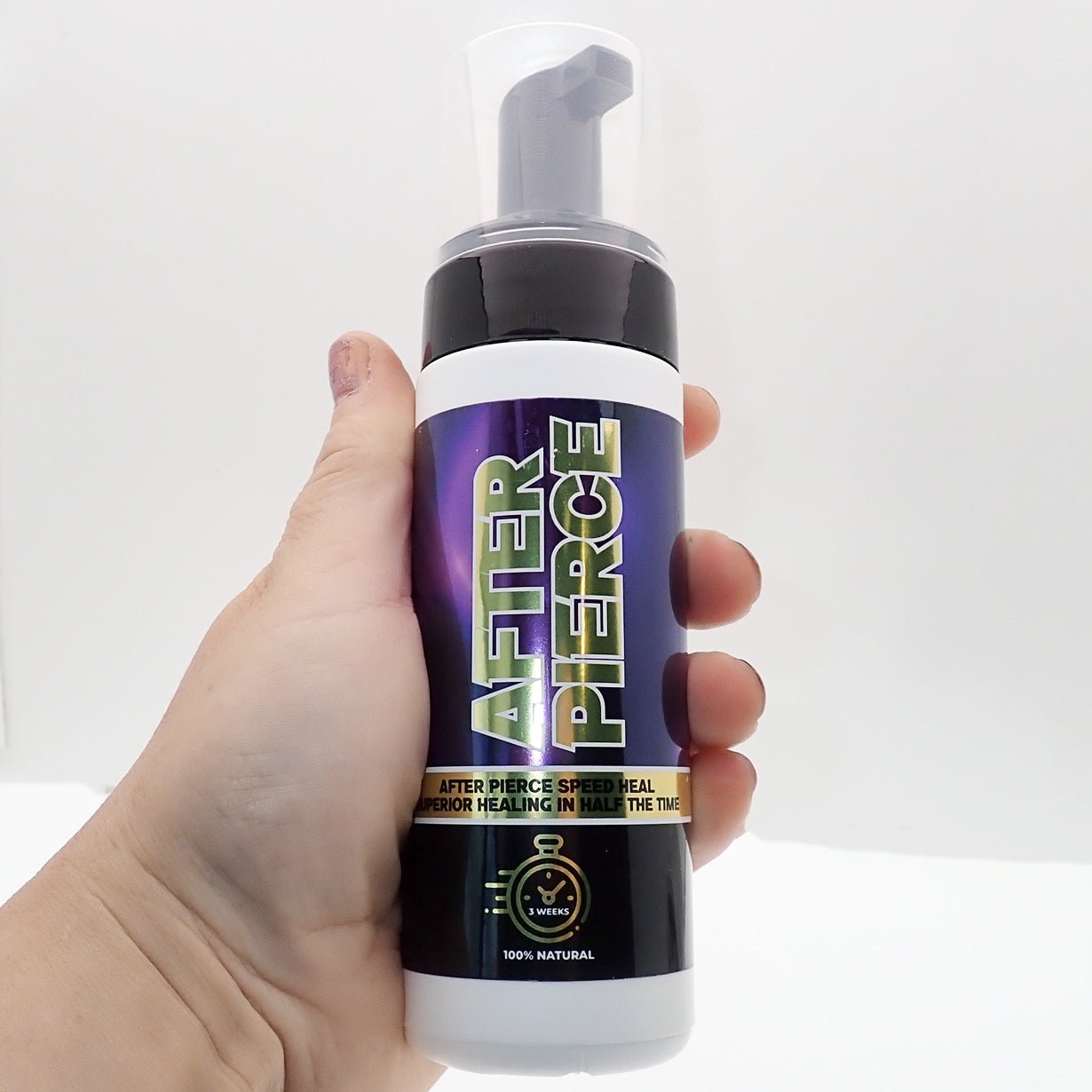 Healing Company After Pierce Foam Spray in 150ml bottle, applying foam for soothing and promoting piercing healing.