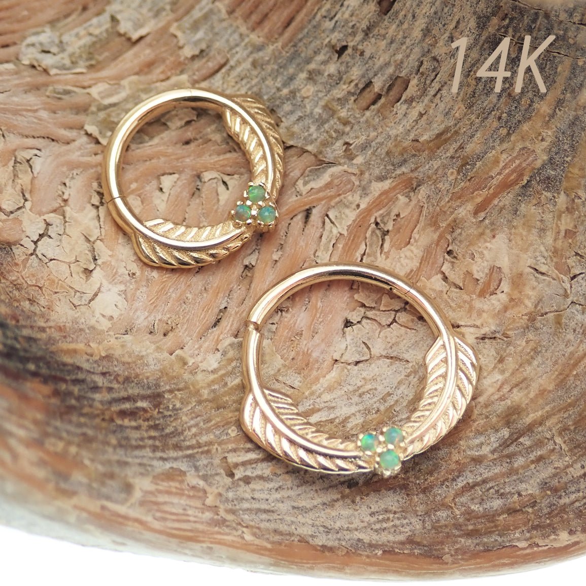 14k solid gold feather and opal hinged clicker earring in 16g by Magpie, featuring green leaf design and vibrant opal accents.