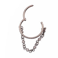 Magpie 16g hinged clicker piercing with dangle chain and cubic zirconia stones, featuring a hinged design for easy wear.