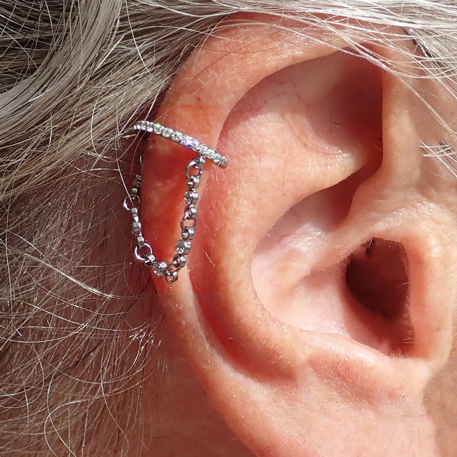 Magpie 16g hinged clicker earring with dangle chain and cubic zirconia for stylish ear piercing.