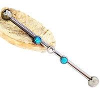 Titanium industrial piercing with a 14g titanium implant featuring an opal ball design, 32mm length.