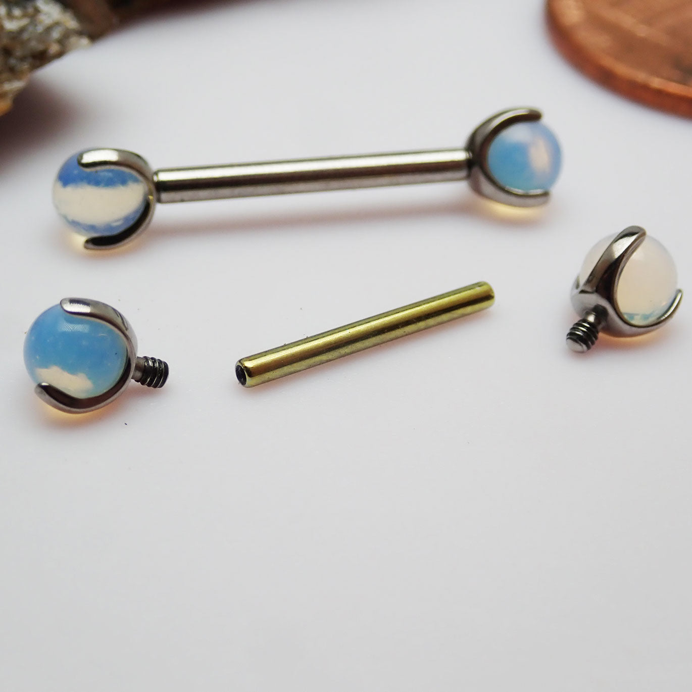 Titanium nipple jewelry with opalite moonstone, 14G internally threaded design, featuring a 10mm smooth, polished gemstone.
